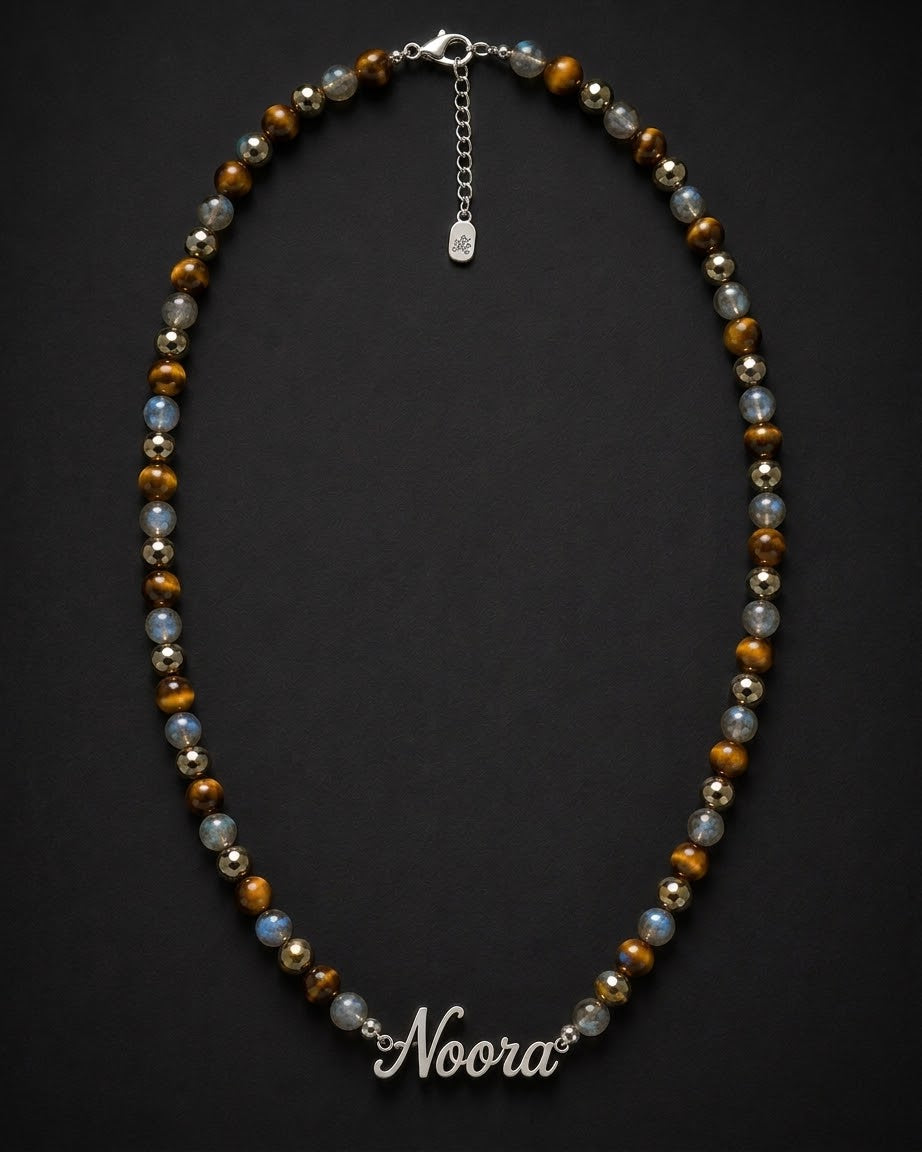 Beaded necklace with 'Noora' clasp on a dark background