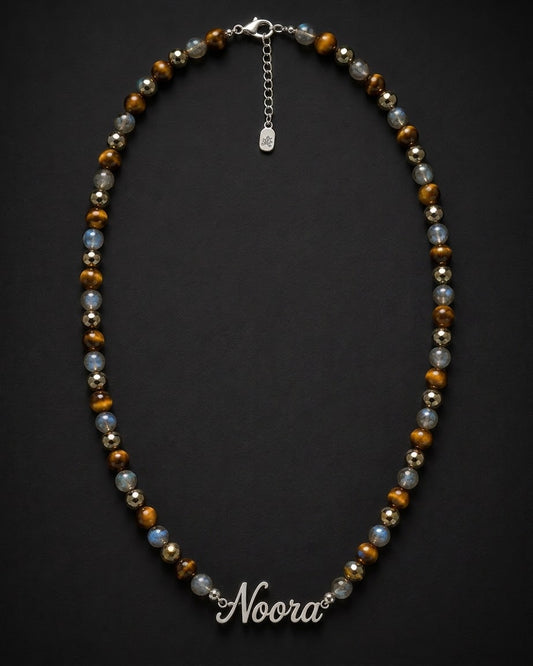 Beaded necklace with 'Noora' clasp on a dark background