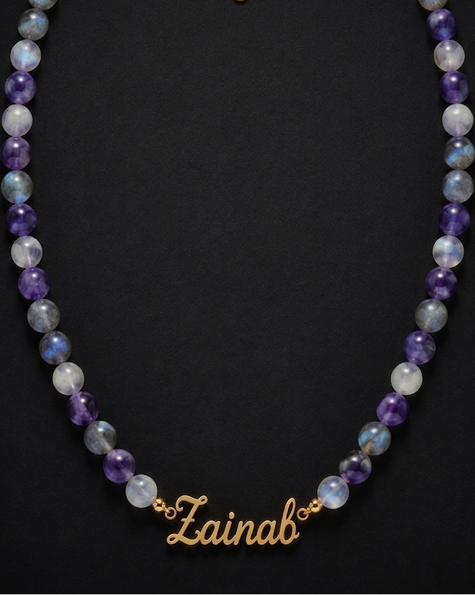 Necklace with multicolored beads and a gold name tag on a black background
