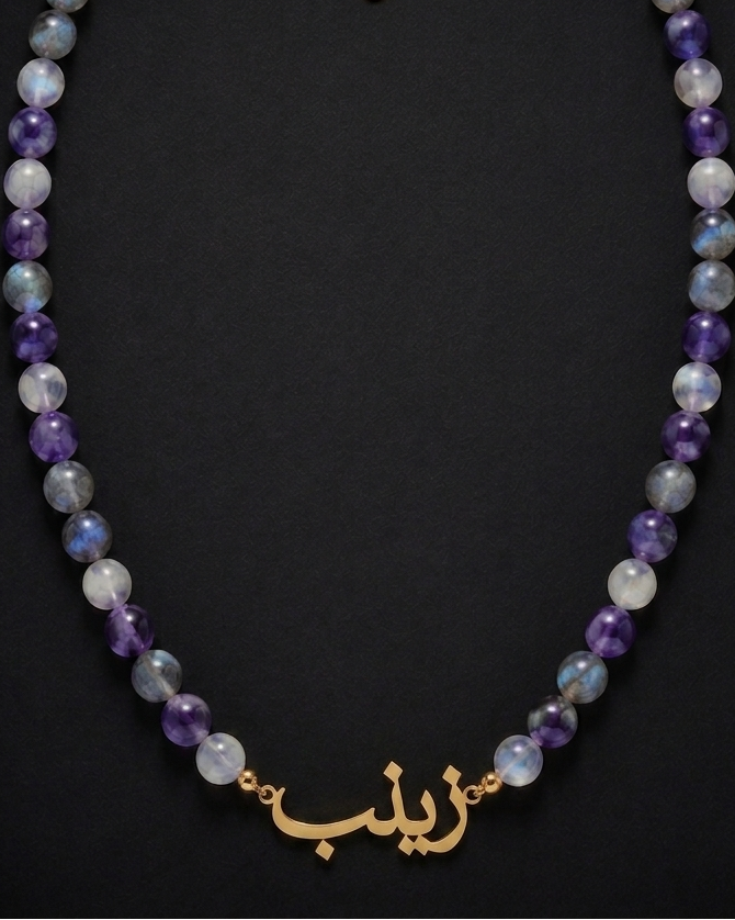 Necklace with multicolored beads and gold clasp on a black background