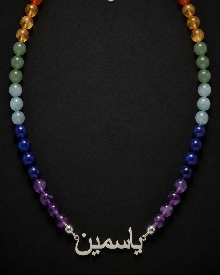 Multicolored beaded necklace with a silver clasp on a black background