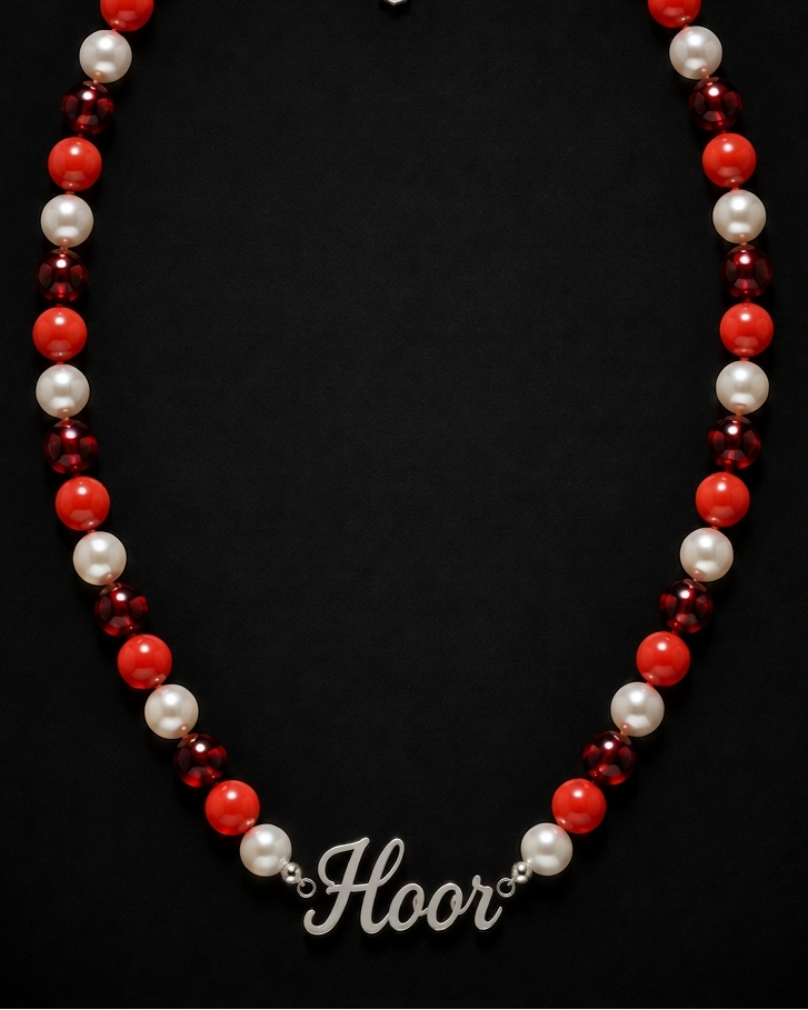 Necklace with red, white, and burgundy beads on a black background