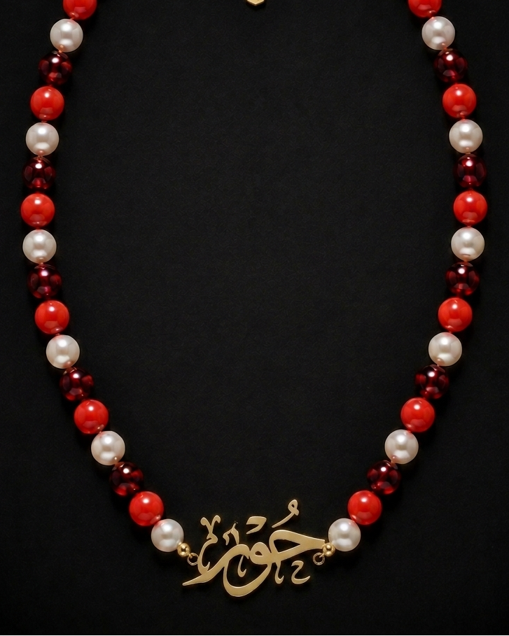 Necklace with red, white, and gold beads on a black background