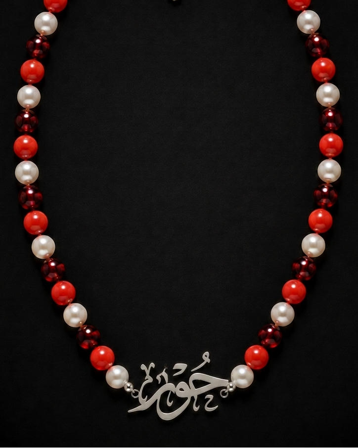 Necklace with red, white, and burgundy beads on a black background