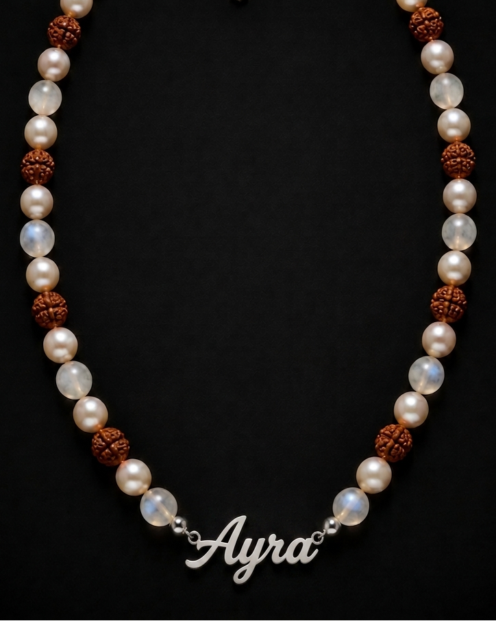 Pearl necklace with brown beads and 'Ayra' clasp on a black background