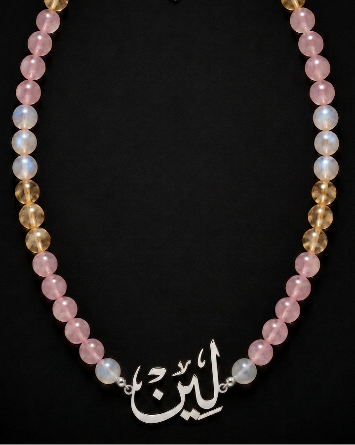 Necklace with multicolored beads and a silver clasp on a black background