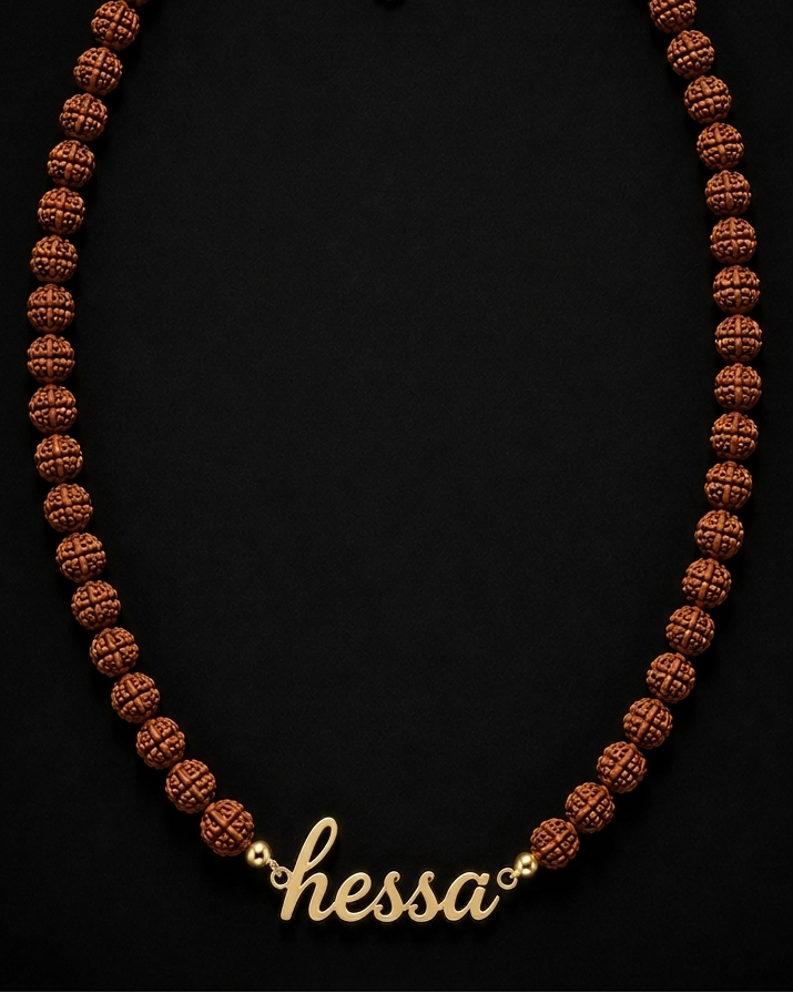 Necklace with brown beads and gold chain on a black background