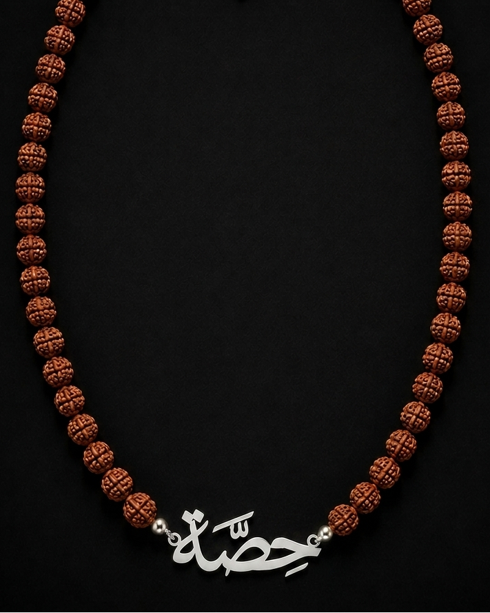 Brown beaded necklace with a silver clasp on a black background
