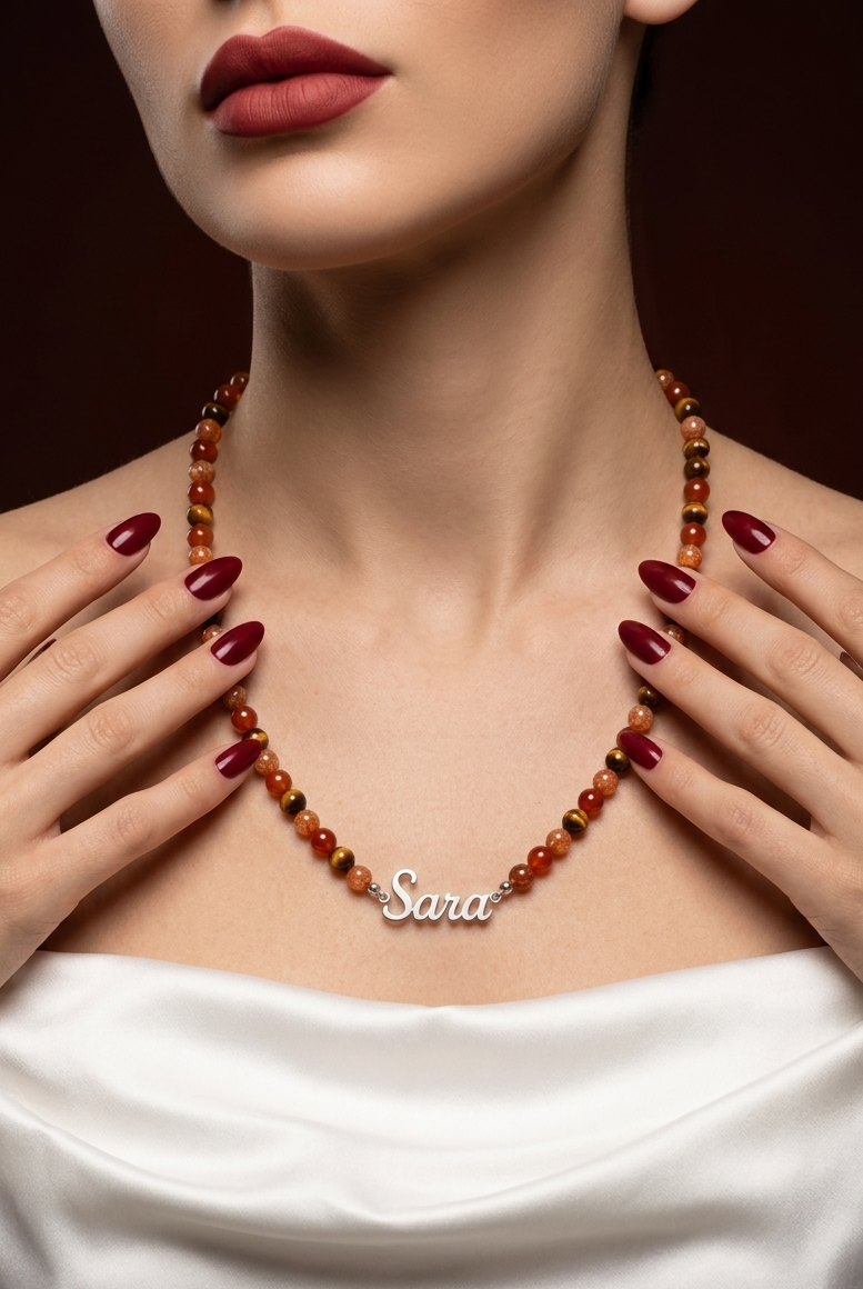 Necklace with 'Sara' pendant worn by a person with red lipstick and white top.