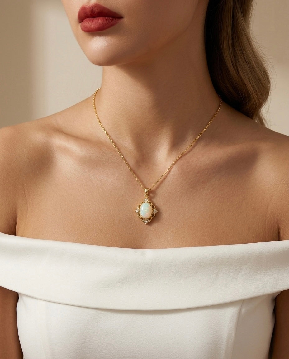 Close-up of a woman wearing a gold necklace with an opal pendant against a neutral background