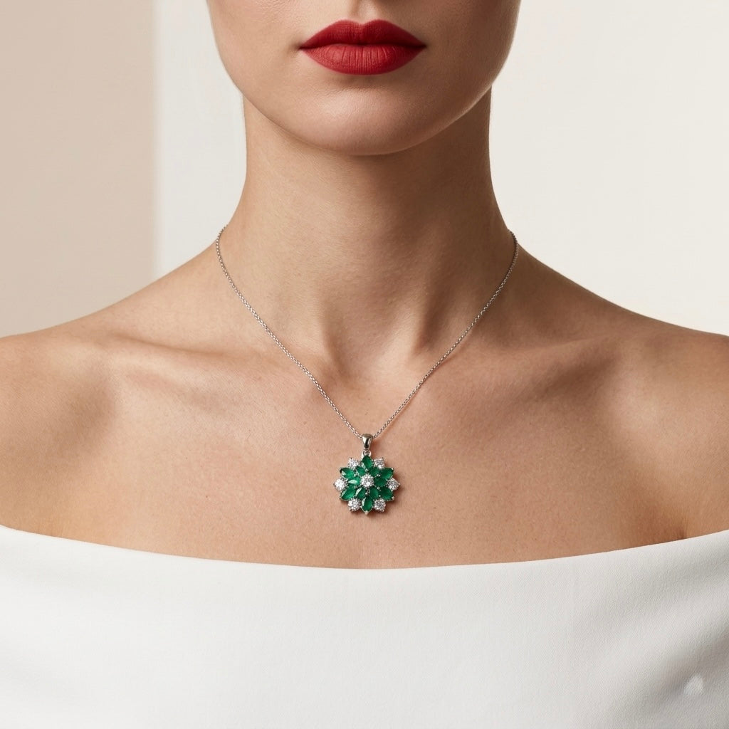 Close-up of a necklace with a green pendant worn by a person against a neutral background