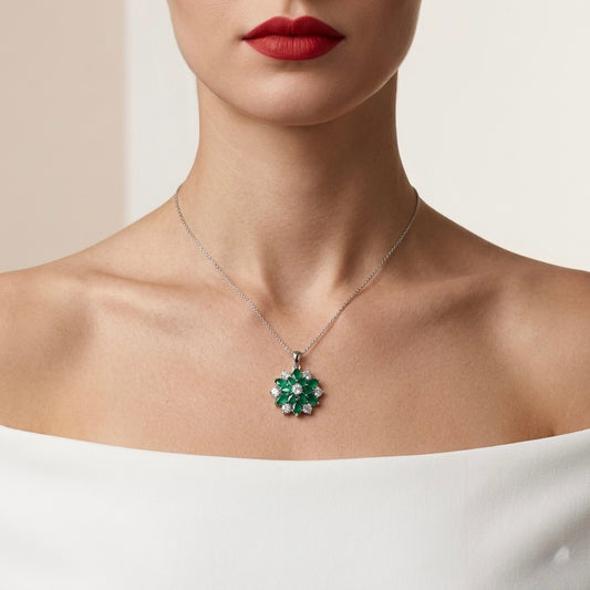 Close-up of a necklace with a green pendant worn by a person against a neutral background