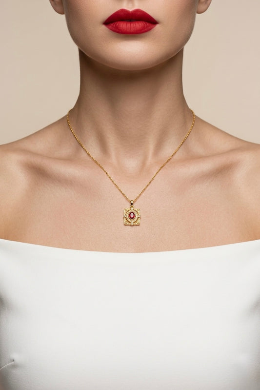 Gold necklace with a pendant worn by a model against a neutral background
