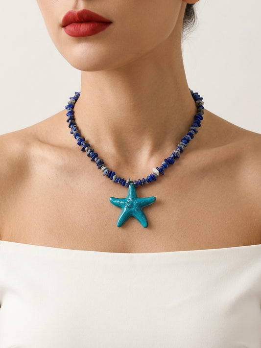 Necklace with a starfish pendant worn by a model against a neutral background
