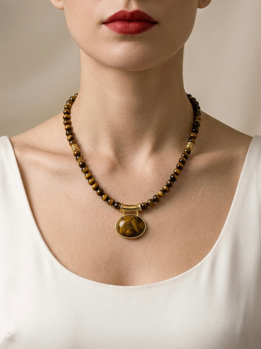 Necklace with a pendant worn by a person against a neutral background