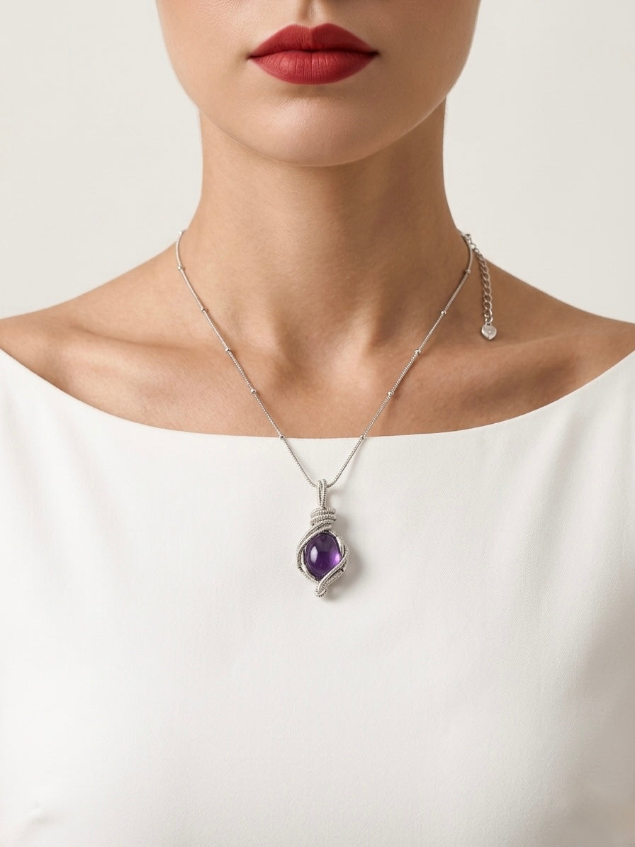 Necklace with a purple pendant worn by a person on a white background