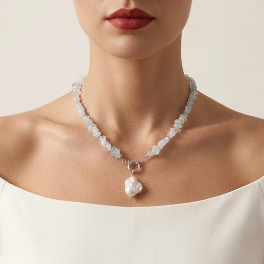 Necklace with a heart-shaped pendant worn by a model against a neutral background