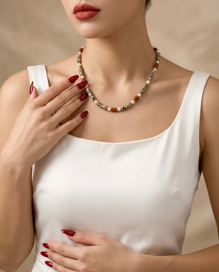 Woman wearing a necklace with a neutral background