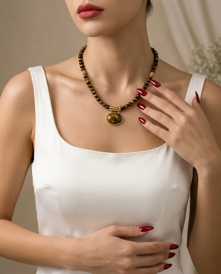 Woman wearing a beaded necklace with a neutral background
