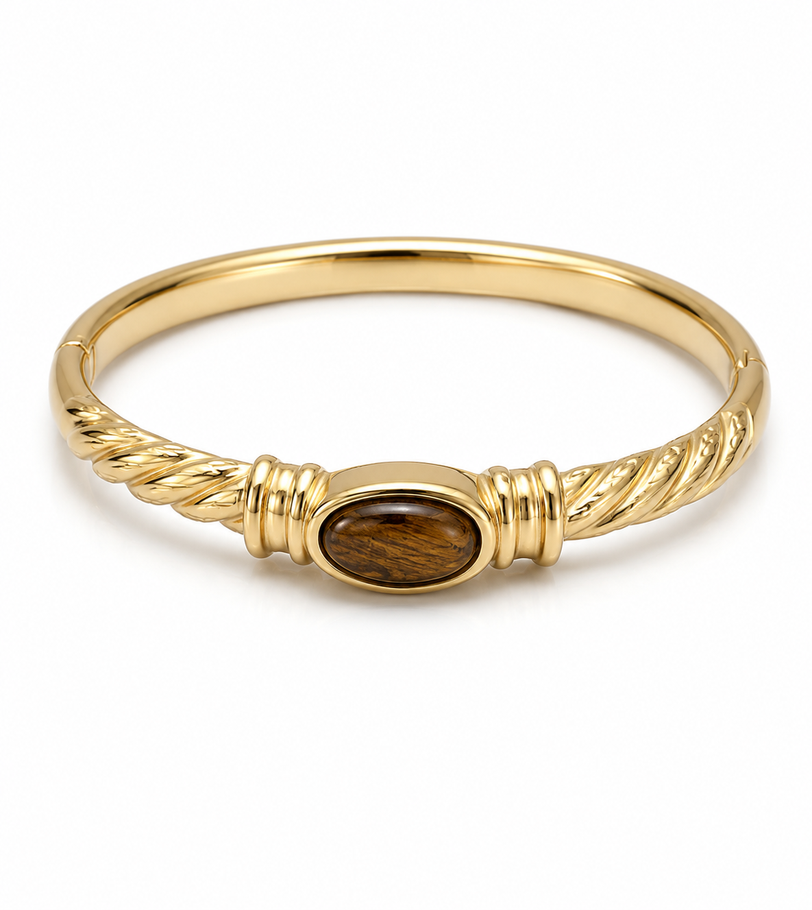 A gold bangle bracelet featuring a central oval inlay of brown tiger's eye stone, set against a plain white background.