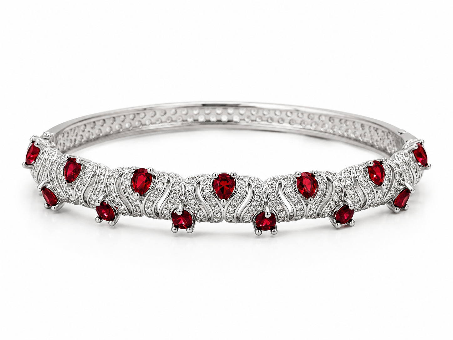 A silver-toned tennis-style bangle bracelet featuring a row of round-cut red gemstones and small clear stones in an openwork pattern, set against a plain white background.