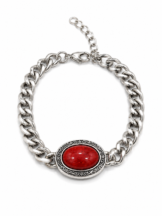 A chunky silver-tone curb chain bracelet featuring a central oval red cabochon stone in an ornate silver bezel, shown on a plain white background.