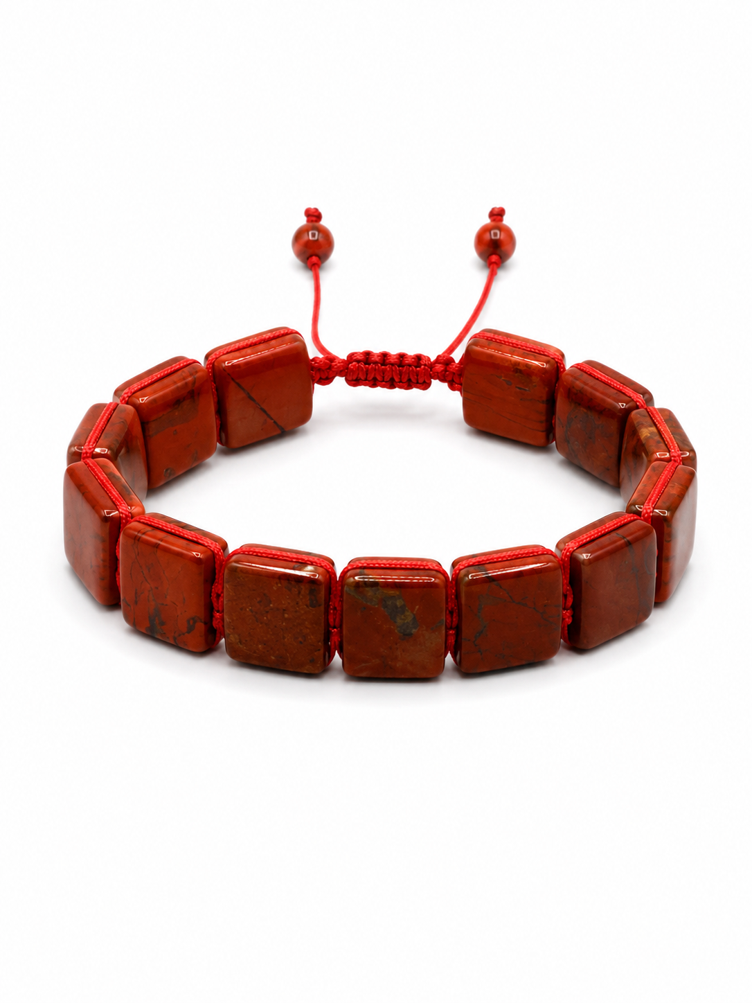 A red beaded bracelet made of square polished stone beads with a red adjustable cord closure, shown on a plain white background.