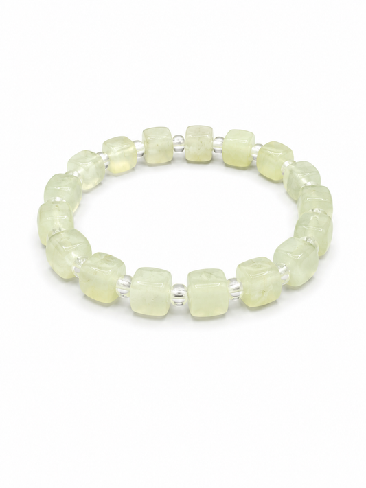 A beaded stretch bracelet featuring pale yellow-green translucent square beads separated by small silver spacer beads, shown on a plain white background.