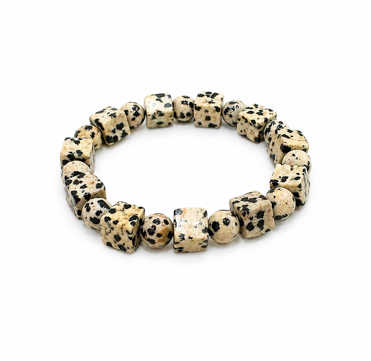 A beaded stretch bracelet made of polished Dalmatian-spotted stone cubes, displayed on a clean white background.