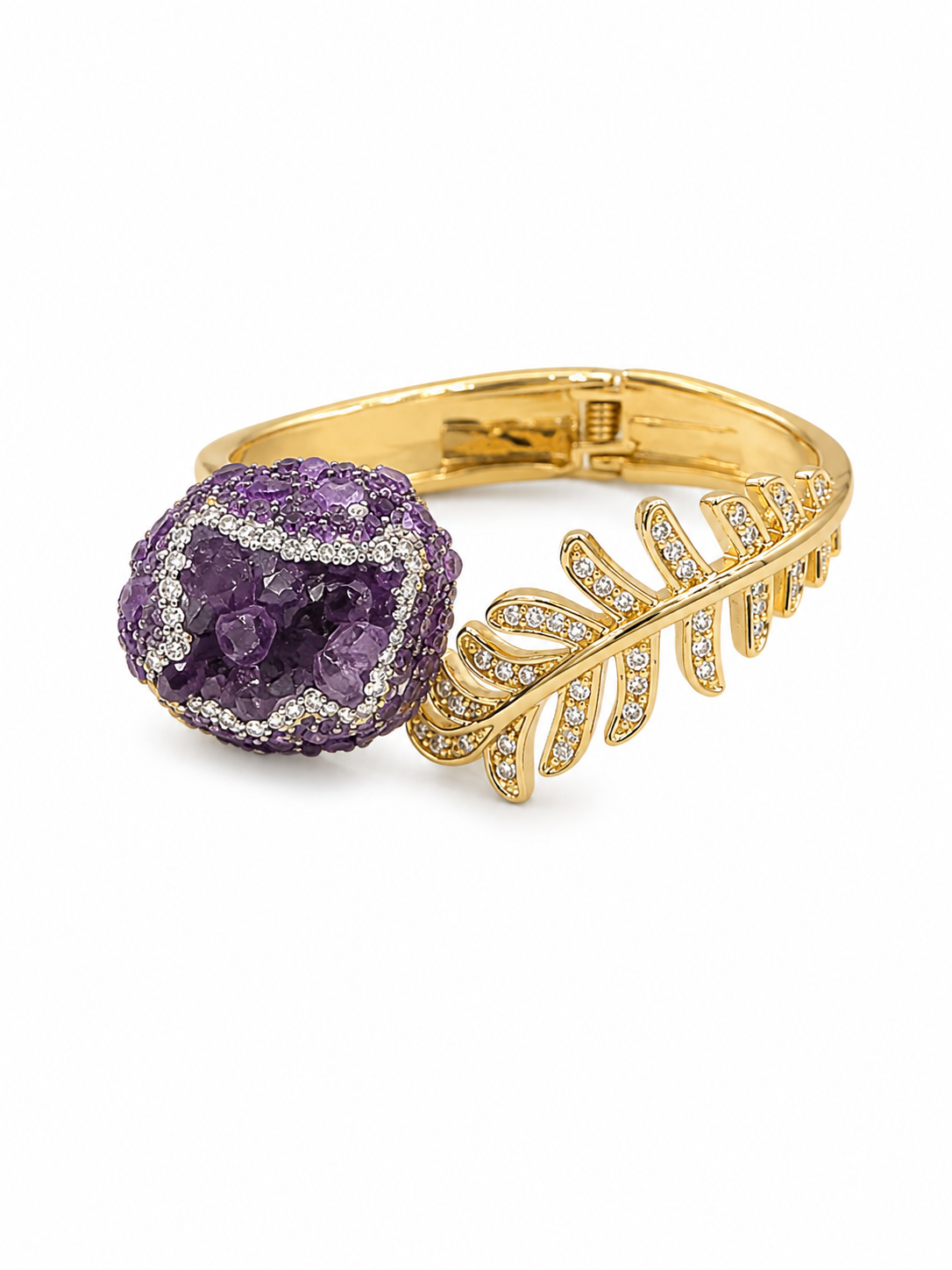 A gold ring featuring a round purple amethyst geode cluster and a leaf-shaped pavé setting with small clear stones, shown on a plain white background.