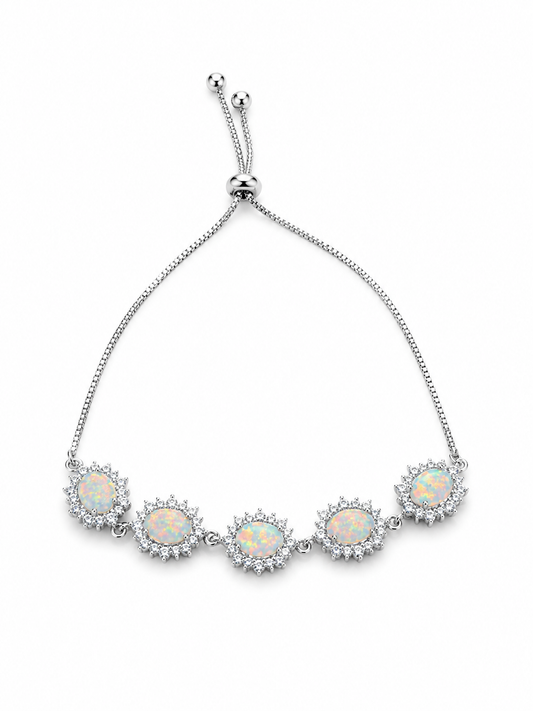 A silver chain bracelet featuring five oval opal gemstones in sunburst settings, surrounded by small clear stones, on a plain white background.