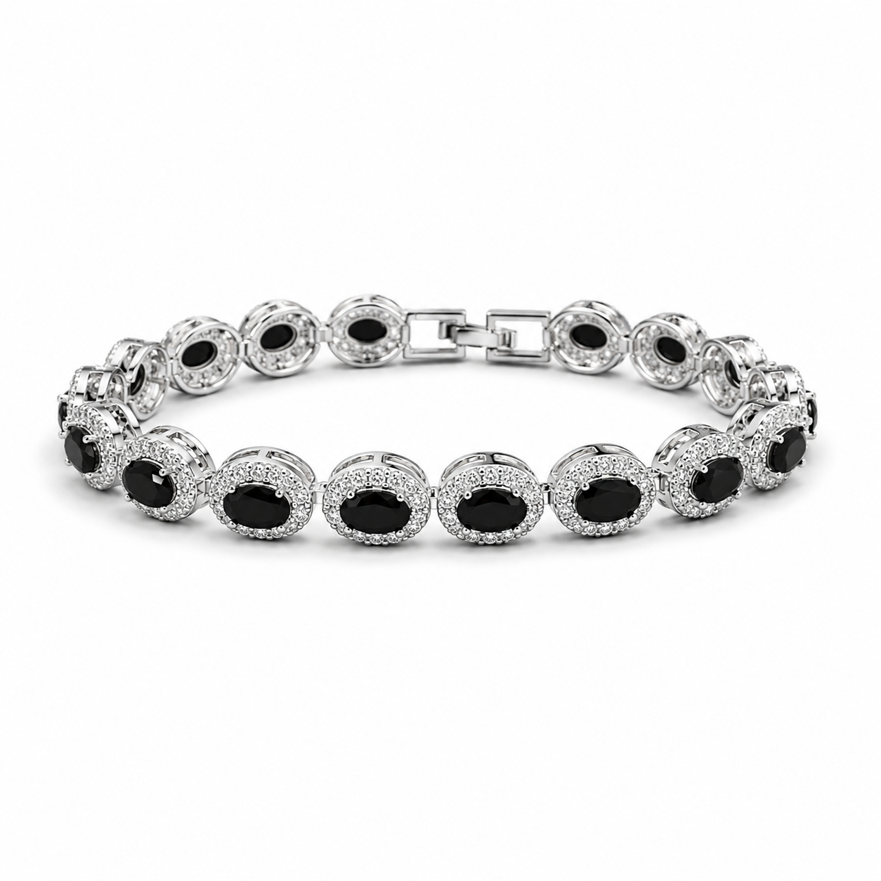 A silver tennis bracelet featuring oval black gemstones surrounded by small clear stones, displayed on a clean white background.