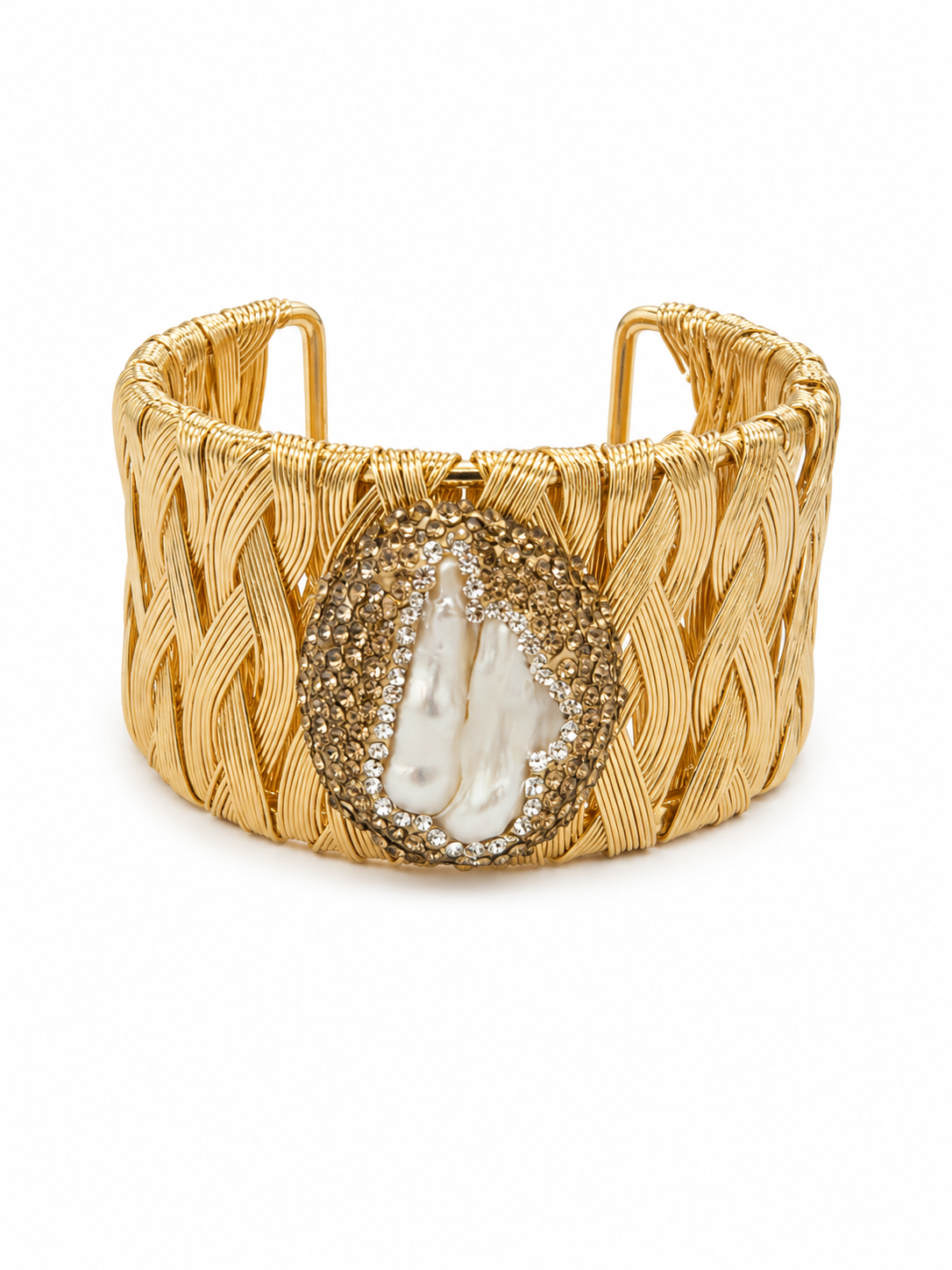 A wide gold-toned cuff bracelet with a textured braided wire pattern and a central oval inlay featuring a white baroque shell surrounded by small clear rhinestones, shown on a plain white background.