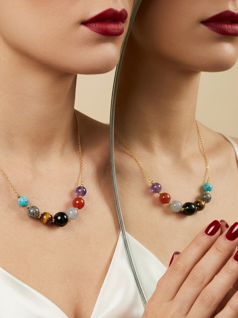 A close-up lifestyle shot of a model wearing a gold chain necklace with a row of colorful, round gemstone beads. The image features a split composition with a mirror reflection showing the necklace from the back, set against a warm beige background.