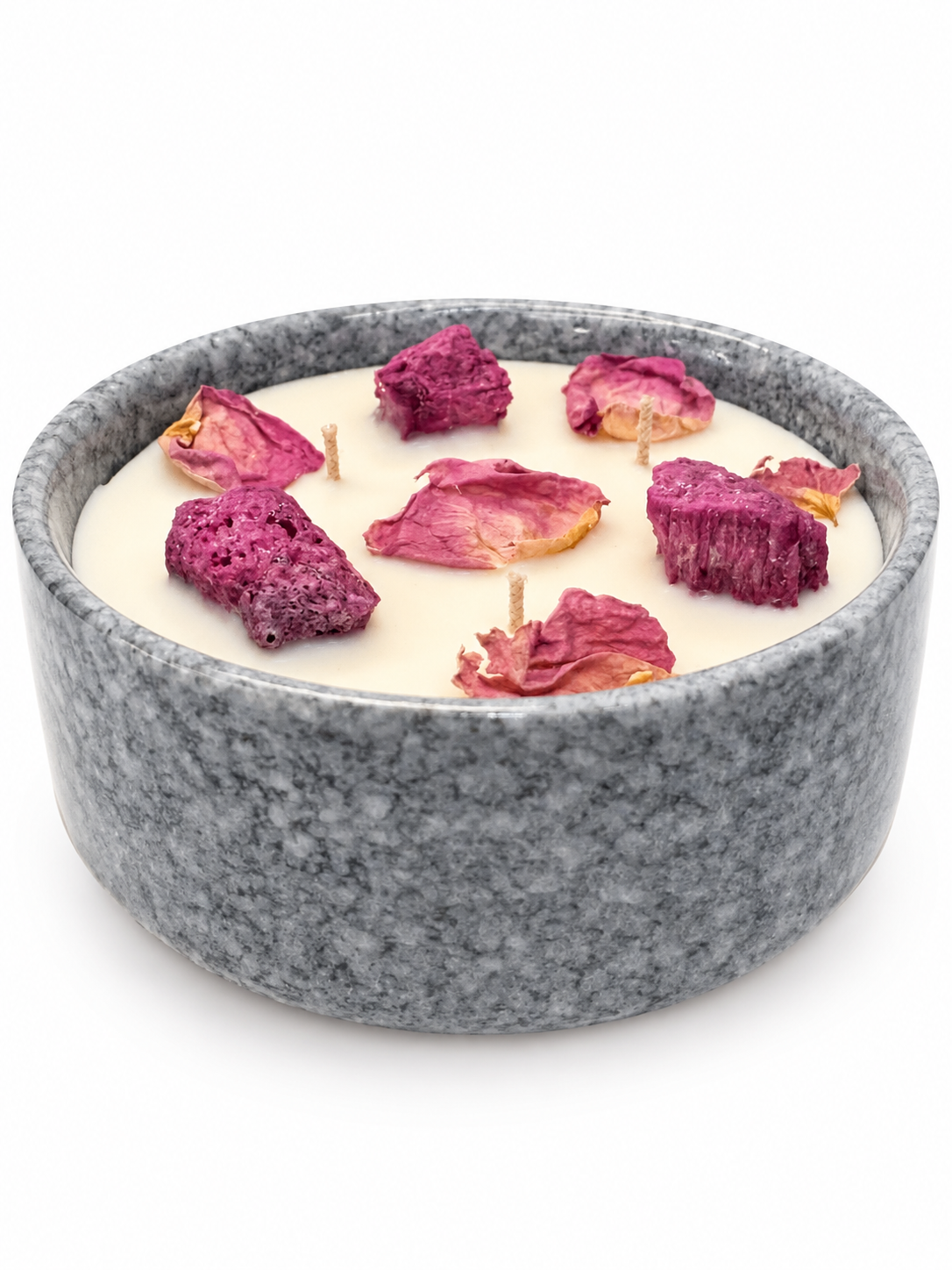 Candle in a gray bowl with dried flowers on a white background