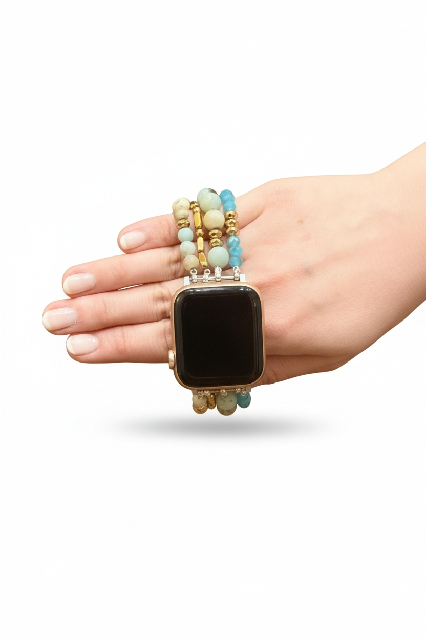 Hand wearing a black smartwatch with a beaded band on a white background