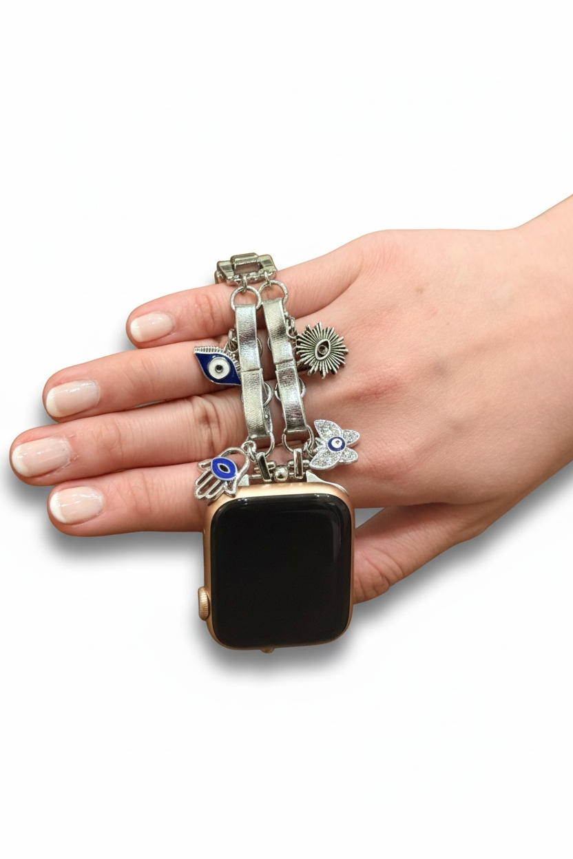 Hand holding a black smartwatch with multiple charm bracelets on a white background