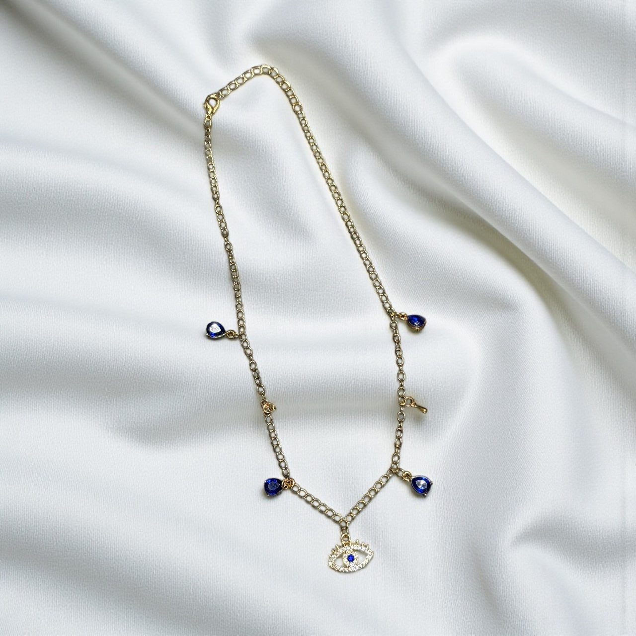 detailed shot of blue evil eye pendant with gold plated accents