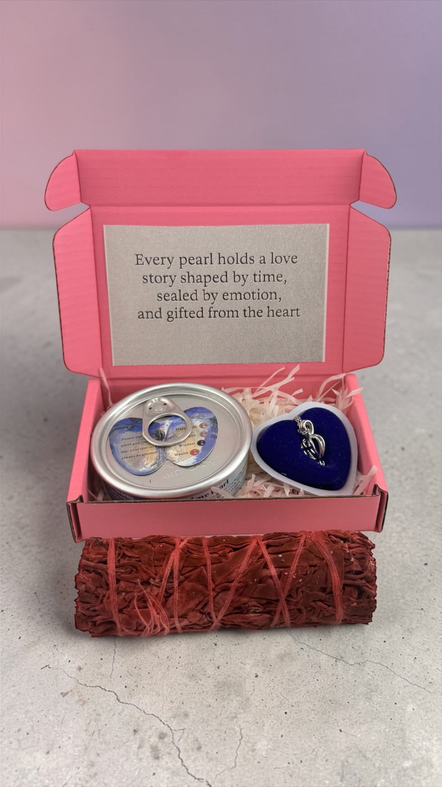 Gift set with pearl containers in a pink box on a light surface.
