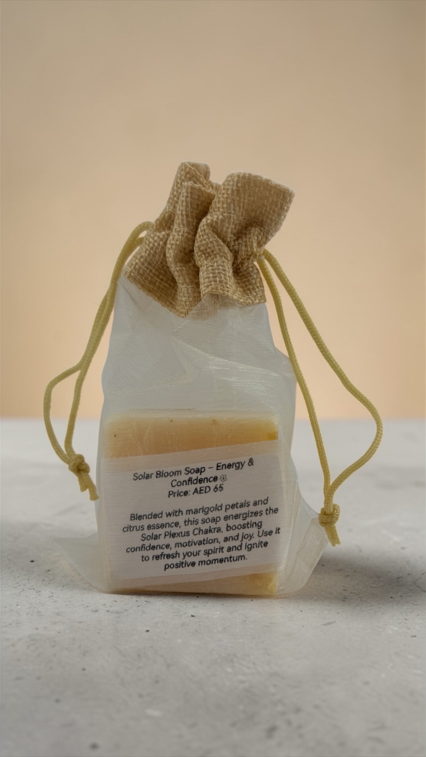 Bar of soap in a drawstring bag with text on a neutral background