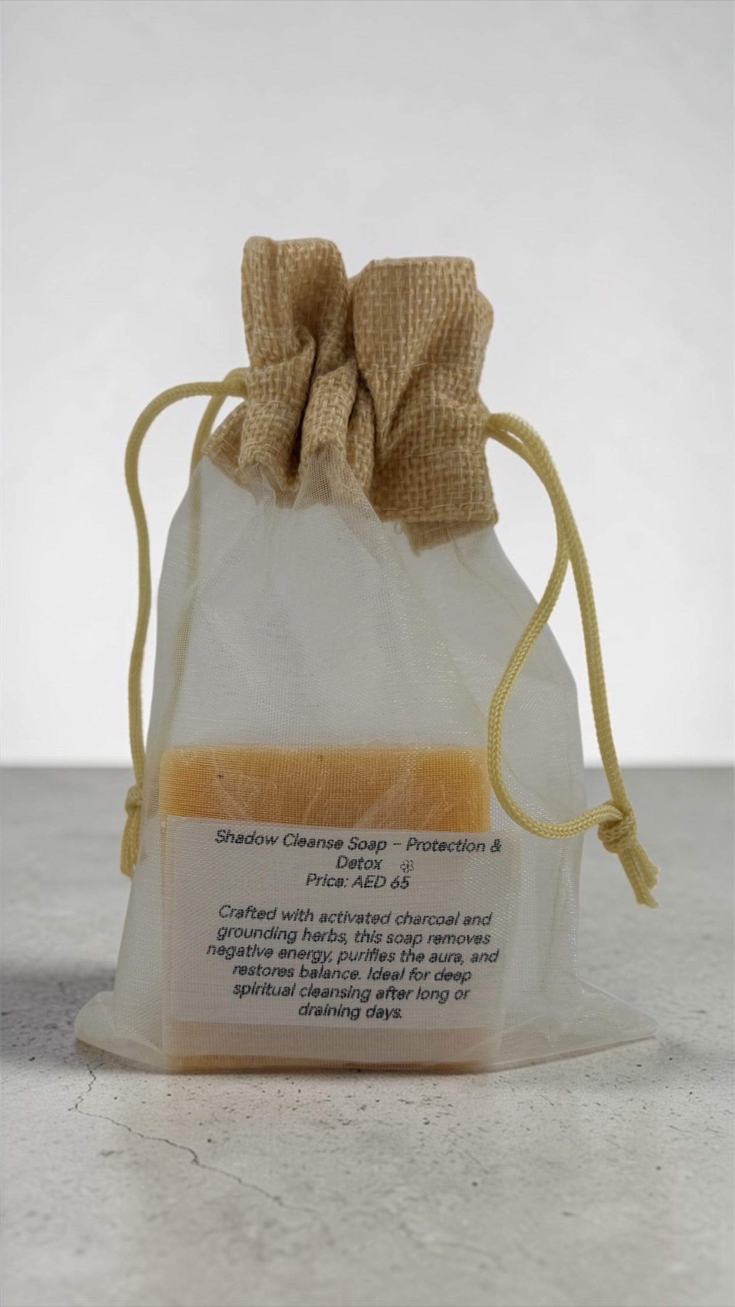 Soap bar in a clear drawstring bag with text on a light background