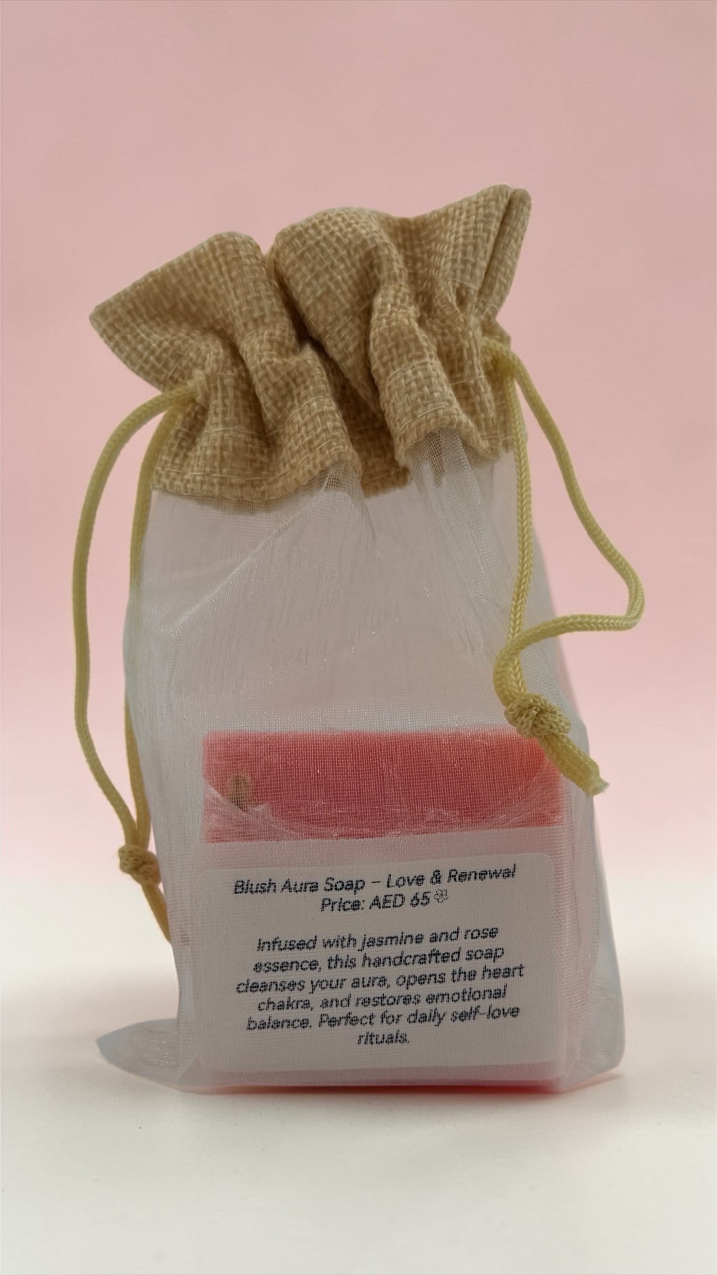 Handmade soap in a burlap bag with text on a pink background