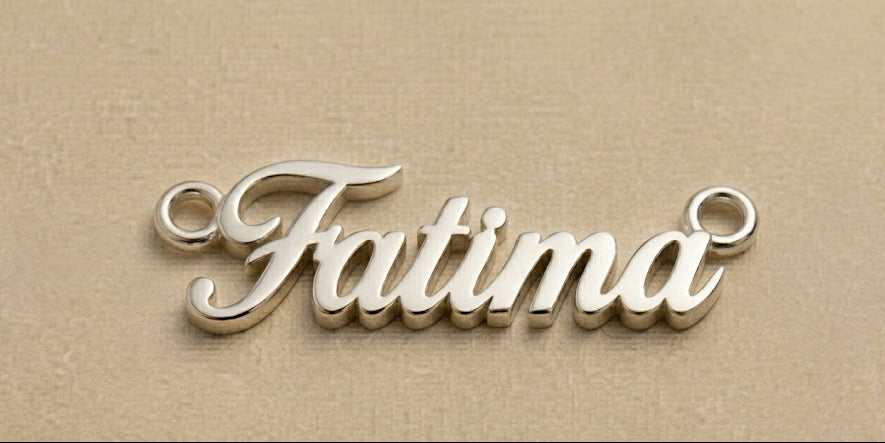 Silver 'Fatima' nameplate on a beige background