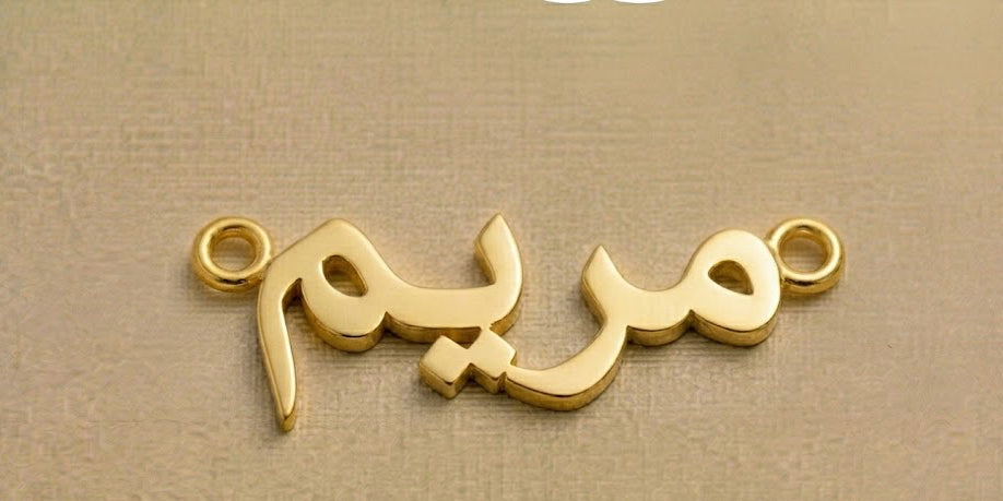 Gold necklace with Arabic script on a beige background