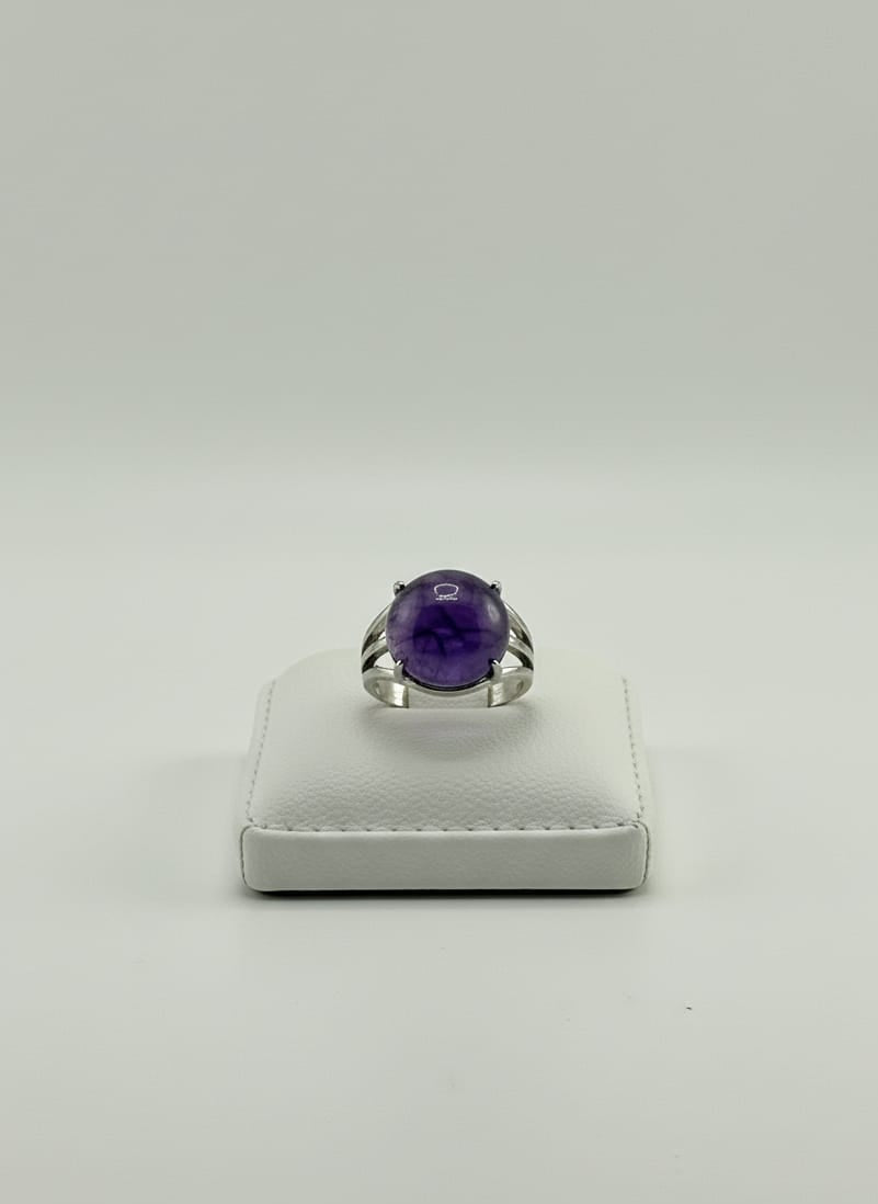 Silver Amethyst men’s ring on hand with soft indoor lighting