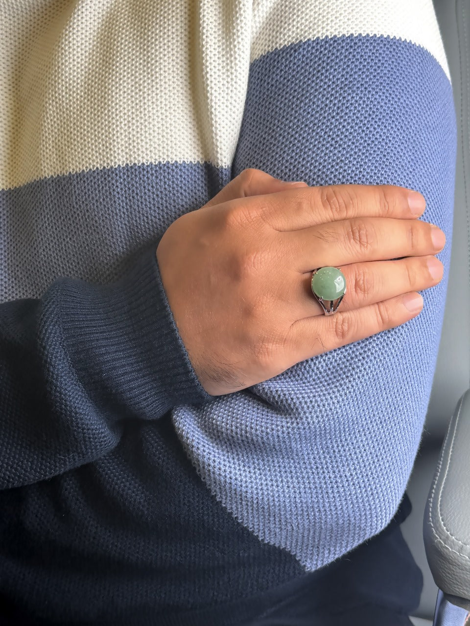 Close up of Green Jade gemstone ring on a man’s hand