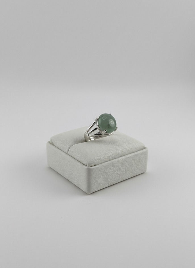 Polished Green Jade stone ring displayed on prop