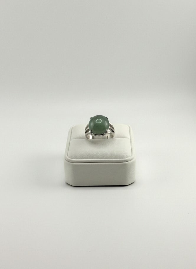 Polished Green Jade stone ring displayed on prop