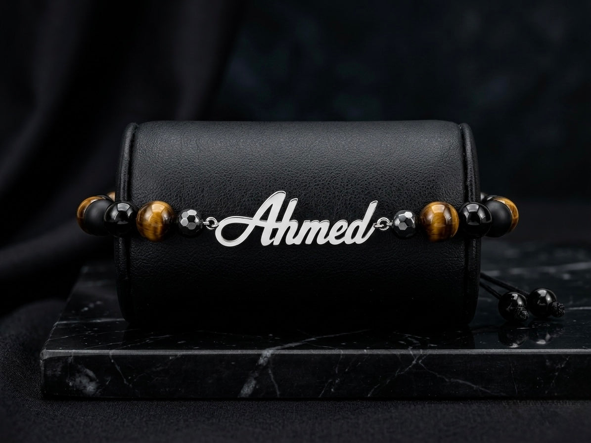 Black bracelet with 'Ahmed' charm on a dark background