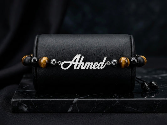 Black bracelet with 'Ahmed' charm on a dark background
